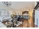 Open living room with hardwood floors and a view of the kitchen at 14969 Elsinore Ave, Parker, CO 80134