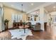 Cozy sitting area with hardwood floors, a cowhide rug, and two armchairs at 14969 Elsinore Ave, Parker, CO 80134