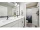 Clean bathroom with double vanity, white cabinets, and shower/tub combo at 15946 Little Bluestem Rd, Monument, CO 80132