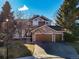 Two-story house with stone accents and a three-car garage at 5016 Cresthill Pl, Highlands Ranch, CO 80130