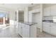 Kitchen features granite island and white cabinetry at 5016 Cresthill Pl, Highlands Ranch, CO 80130