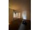 Large living room with carpeted floors and access to other rooms at 10772 E Exposition Ave # 141, Aurora, CO 80012