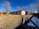 Large backyard with grass, trees, and a gravel area at 4691 S Kittredge Way, Aurora, CO 80015
