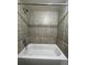 Clean bathroom with a bathtub and tiled walls at 4691 S Kittredge Way, Aurora, CO 80015