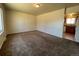 Bright living room with carpet flooring and access to kitchen at 4691 S Kittredge Way, Aurora, CO 80015
