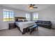 Spacious bedroom with large windows, a comfortable bed, and additional seating at 41860 Muirfield Loop, Elizabeth, CO 80107