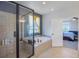 Spa-like bathroom with a soaking tub, separate shower, and large window at 41860 Muirfield Loop, Elizabeth, CO 80107