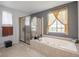 Bathroom with soaking tub and separate shower, offering natural light at 41860 Muirfield Loop, Elizabeth, CO 80107