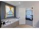 Bathroom with a large soaking tub and a view into the bedroom at 41860 Muirfield Loop, Elizabeth, CO 80107