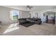 Large living room with a sectional sofa and views to the kitchen and backyard at 41860 Muirfield Loop, Elizabeth, CO 80107