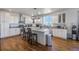 Bright kitchen with white cabinets, stainless steel appliances, and hardwood floors at 41860 Muirfield Loop, Elizabeth, CO 80107