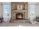 Inviting stone fireplace with a rustic wooden mantel in a spacious living room at 41860 Muirfield Loop, Elizabeth, CO 80107