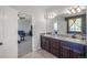 Double vanity bathroom with granite countertops and a large mirror at 41860 Muirfield Loop, Elizabeth, CO 80107