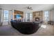 Open living room with a large sectional sofa and stone fireplace at 41860 Muirfield Loop, Elizabeth, CO 80107