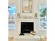 White brick fireplace with decorative mantle and artwork above at 12414 W 85Th Ave, Arvada, CO 80005