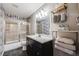 Clean bathroom, featuring a shower/tub combo and dark vanity at 1181 Yosemite St, Denver, CO 80220