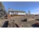 House exterior with deck and garden beds at 3601 Sunrise Ln, Brighton, CO 80603
