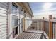 Deck with pet door and view of yard at 3601 Sunrise Ln, Brighton, CO 80603