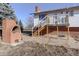 Brick patio with raised deck and fire pit at 3601 Sunrise Ln, Brighton, CO 80603