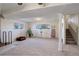 Finished basement with a staircase, fireplace, and large windows at 3601 Sunrise Ln, Brighton, CO 80603