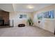 Bright basement Gathering room with a fireplace, large windows, and plants at 3601 Sunrise Ln, Brighton, CO 80603