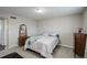 Simple bedroom with a double bed, dresser and an antique mirror at 3601 Sunrise Ln, Brighton, CO 80603