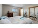 Bright bedroom with a double bed, dresser, and mirrored vanity at 3601 Sunrise Ln, Brighton, CO 80603