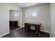 Bedroom with a desk, mirrored closet, and dark hardwood floors at 3601 Sunrise Ln, Brighton, CO 80603
