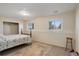 Basement bedroom with a floral bedspread and a small stool at 3601 Sunrise Ln, Brighton, CO 80603
