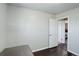 Bright bedroom with an open door to another room and dark hardwood floors at 3601 Sunrise Ln, Brighton, CO 80603