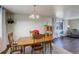 Spacious dining area with hardwood floors and a view into the living room at 3601 Sunrise Ln, Brighton, CO 80603