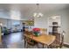 Dining room with wood table and chairs, and a view into the kitchen at 3601 Sunrise Ln, Brighton, CO 80603