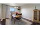 Charming dining room with a wood table and chairs, and an area rug at 3601 Sunrise Ln, Brighton, CO 80603