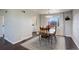 Bright dining room featuring a wood table, four chairs, and a view to the kitchen at 3601 Sunrise Ln, Brighton, CO 80603