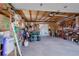 Attached garage with ample storage and various tools and equipment at 3601 Sunrise Ln, Brighton, CO 80603