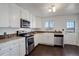 Well-equipped kitchen, featuring white cabinets and stainless steel appliances at 3601 Sunrise Ln, Brighton, CO 80603