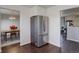 Stainless steel refrigerator in kitchen with hardwood floors and view of dining area at 3601 Sunrise Ln, Brighton, CO 80603