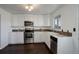 Modern kitchen with white cabinets, stainless steel appliances, and tile backsplash at 3601 Sunrise Ln, Brighton, CO 80603