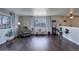 Bright living room with hardwood floors, a window seat and a half wall at 3601 Sunrise Ln, Brighton, CO 80603