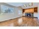 Spacious living room featuring hardwood floors, a fireplace, and skylights at 3624 S Ivory Ct, Aurora, CO 80013