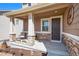 Inviting front porch with stone accents and comfortable seating at 42395 Forest Oaks Dr, Elizabeth, CO 80107