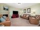 Gathering room with fireplace, leather couches, and built-in entertainment center at 42395 Forest Oaks Dr, Elizabeth, CO 80107