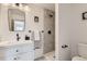 Updated bathroom with patterned shower tile, white vanity, and modern fixtures at 486 Leona Dr, Denver, CO 80221