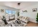 Bright living room with beige couch, two armchairs, and a coffee table at 486 Leona Dr, Denver, CO 80221