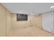 Finished basement room with a large TV and carpeted floors at 4848 Hooker St, Denver, CO 80221