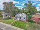 House with gray siding, a well-manicured lawn, and mature trees at 4848 Hooker St, Denver, CO 80221