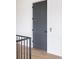 Modern elevator access with a dark gray door and wood floors at 7875 Raphael Ln, Littleton, CO 80125