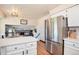 Modern kitchen with stainless steel appliances and white cabinets, offering an open layout at 7311 W Weaver Pl, Littleton, CO 80123