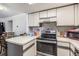View of kitchen with stainless steel stove and microwave at 12503 E Pacific Cir # E, Aurora, CO 80014