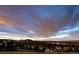 Aerial view of houses on a hillside with dramatic sky at 872 Eveningsong Dr, Castle Rock, CO 80104